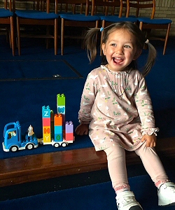 Engineer Maya built the Alphabet train today.  She looks very happy with her success.