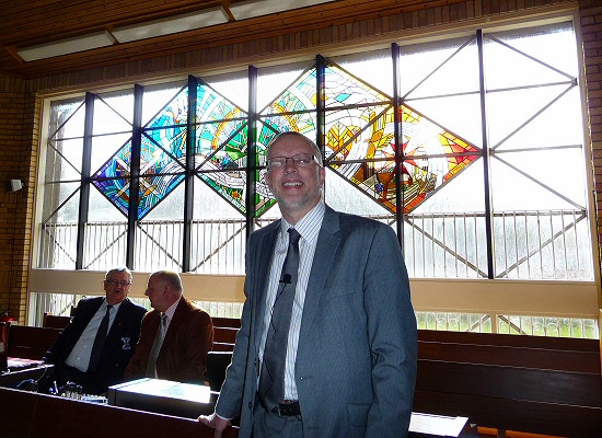 Rev. Robin McAlpine with the new stained glass windows